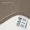 A close-up of a taupe fabric with text and care symbols. Produktbild-Vorschau