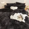 A close-up view of a bed with plush bedding and pillows, featuring a magazine and a small clutch bag. Anteprima dell’immagine prodotto