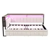 A beige upholstered daybed with a wooden frame and pink LED lighting. Voir les images du produit