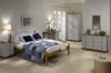 A bedroom scene with a bed, nightstand, dresser, and wardrobe. Produktbild-Vorschau