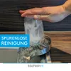 A hand is shown pressing a glass onto a kitchen sink attachment, with water spraying from the attachment to clean the inside of the glass. Produktbild-Vorschau