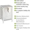 A white wooden laundry basket with a beige towel hanging out, next to a list of its features in English and German. Produktbild-Vorschau