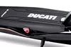 A close-up view of the deck of a black electric scooter, featuring the Ducati logo and branding. Náhled obrázku produktu
