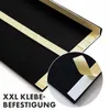 A close-up view of the back of a black product, showing adhesive strips for mounting. A magnified inset shows the adhesive tape being peeled off. Anteprima dell’immagine prodotto