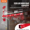 A red electric hoist support arm mounted on a gray wall, with text overlays highlighting its features and specifications. Náhľad obrázku produktu
