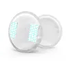 Two round, white breast pads are shown against a white background. The front pad has two light blue strips with a repeating pattern of diagonal lines. Voir les images du produit