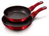 Two red frying pans stacked on a white background. Podgląd zdjęcia produktu
