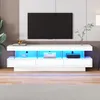 A modern white TV stand with LED lighting is shown in a living room setting. Náhľad obrázku produktu