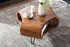 A wooden coffee table with a vase of flowers, a teacup, and a book on it, placed on a rug. Produktbild-Vorschau