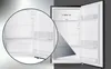 An open refrigerator with a close-up view of its interior shelves. Produktbild-Vorschau