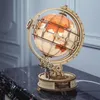 A wooden globe model with internal lighting sits on a marble surface. Náhľad obrázku produktu