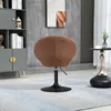 A brown lounge chair with a black base is placed on a light blue and white rug in a room with a gray cabinet and a marble-patterned wall. Produktbild-Vorschau