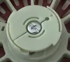 A close-up view of a starter mechanism with a screw in the center. Náhľad obrázku produktu