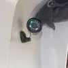 A close-up of a security camera mounted on a white wall. Produktbild-Vorschau