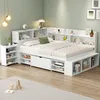 A white bed frame with built-in shelving and drawers, set up in a room with light green walls and a wooden floor. Produktbild-Vorschau