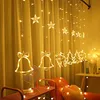 Christmas lights with star, bell, and reindeer shapes hanging in front of yellow curtains. Náhled obrázku produktu