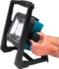 A person's hands are adjusting a knob on a portable LED work light. Podgląd zdjęcia produktu