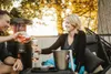 A couple enjoying drinks on a patio with a patio heater in the background. Produktbild-Vorschau