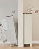A split image showing a cabinet toppling over on the left (with a thumbs down icon) and a secured cabinet on the right (with a thumbs up icon and a diagram of anti-tip hardware). Náhled obrázku produktu