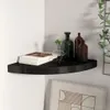 A black corner shelf mounted on a white wall, decorated with books and glass bottles. Náhľad obrázku produktu
