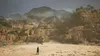 A person stands in a desolate, rocky landscape with mountains in the background. Náhľad obrázku produktu