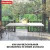 A white folding table is set up on a wooden deck outdoors, with lush greenery and trees in the background. Náhled obrázku produktu