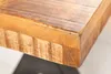 Close-up of the corner of a wooden table with black metal legs. Produktbild-Vorschau