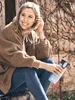 A woman sitting outdoors with a reusable water bottle. Náhled obrázku produktu