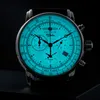 A close-up, studio shot of a men's chronograph watch with a luminous blue dial, set against a black background. Náhled obrázku produktu