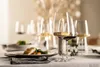 A table setting with wine glasses and a plate of food. Náhled obrázku produktu