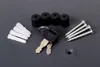 A collection of hardware components, including keys, screws, wall plugs, and rubber feet, laid out on a gray surface. Náhled obrázku produktu
