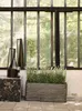 A rectangular planter filled with lavender sits on a patio in front of a large, multi-paned window. Two decorative black lanterns are placed to the left of the planter on a dark, marbled block. Náhľad obrázku produktu
