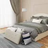 A bedroom scene with a bed, curtains, and a storage ottoman. Náhľad obrázku produktu