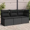 A black three-seater outdoor sofa with cushions, placed on a paved patio with a wooden fence and string lights in the background. Produktbild-Vorschau