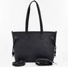 A black tote bag with embossed logos and patterns, shown against a white background. Two separate straps are placed in front of the bag. Produktbild-Vorschau