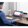 A person is working at a desk with a laptop, keyboard, and other accessories. Produktbild-Vorschau