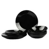 A set of black dinnerware, including plates and bowls, is neatly arranged against a white background. Náhled obrázku produktu
