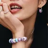 Close-up of a woman's hand and mouth, wearing jewelry. Anteprima dell’immagine prodotto