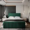 A modern bedroom with a green upholstered bed as the focal point. Produktbild-Vorschau