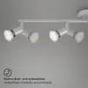 A close-up view of a silver LED track light fixture with four adjustable spotlights mounted on a white ceiling. Produktbild-Vorschau
