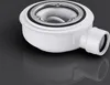 A white shower drain with a silver metal rim, shown on a dark gray reflective surface. Voir les images du produit
