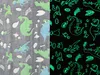 A split image showing a blanket with dinosaur patterns. The left side shows the blanket in normal light, and the right side shows it glowing in the dark. Náhled obrázku produktu