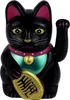 A black Maneki-neko (lucky cat) figurine with a gold coin. Produktbild-Vorschau