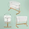 A collage of three images showing a baby bassinet from different angles and with different height adjustments, against a light green background. Produktbild-Vorschau