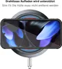 A smartphone in a black case is placed on a wireless charging pad, which is connected to a cable. Produktbild-Vorschau
