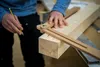 A person is using a marking tool on a wooden beam. Anteprima dell’immagine prodotto