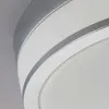 A close-up view of a ceiling lamp with white and silver accents. Produktbild-Vorschau