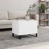 A white coffee table with black legs sits on a gray rug in front of a sofa. A vase with a plant is on the table. A bookshelf is in the background. Anteprima dell’immagine prodotto