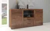 A wooden sideboard with drawers and cabinets, placed in a room with a window and a gray wall.