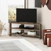 A modern corner TV stand with a television and media devices in a living room setting. Podgląd zdjęcia produktu